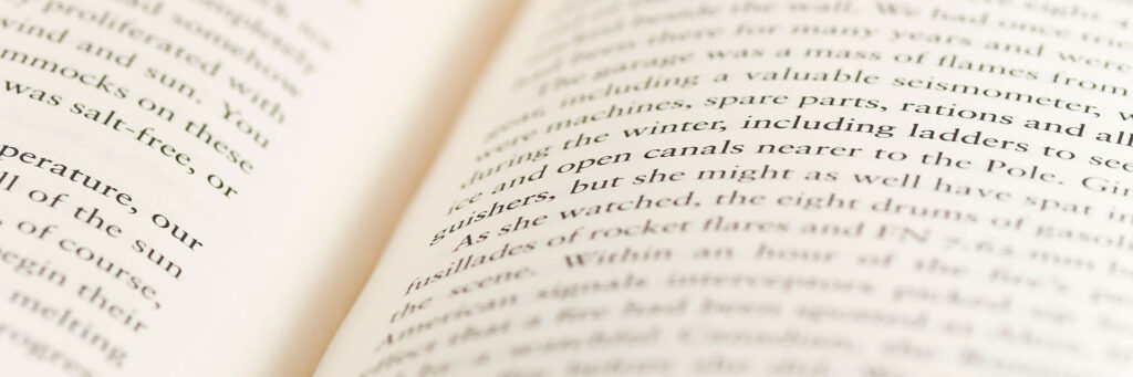 closeup of open book with blurred text